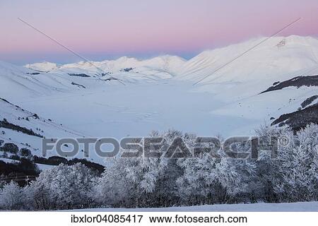 Stock Photo - Piano Grande of Castelluccio di Norcia at sunset in winter, Sibillini Mountains National Park, Umbria, Italy, Europe. Fotosearch