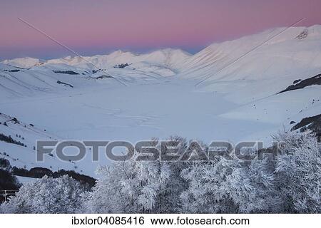 Stock Photograph - Piano Grande of Castelluccio di Norcia at sunset in winter, Sibillini Mountains National Park, Umbria, Italy, Europe. Fotosearch