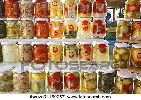 Pickled peppers, cucumbers, onions and other vegetables in glasses with funny faces, farmers' market on Lake Balaton, Hungary, Europe View Large Photo Image Stock Photo - Pickled peppers, cucumbers, onions and other vegetables in glasses with funny faces, farmers' market on Lake Balaton, Hungary, Europe. Fotosearch