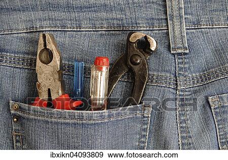 Stock Photo - Pliers and screwdrivers in a back pocket, DIY. Fotosearch