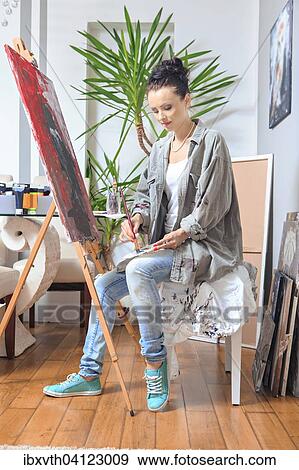 Stock Photo - Portrait of a female painter at work. Fotosearch