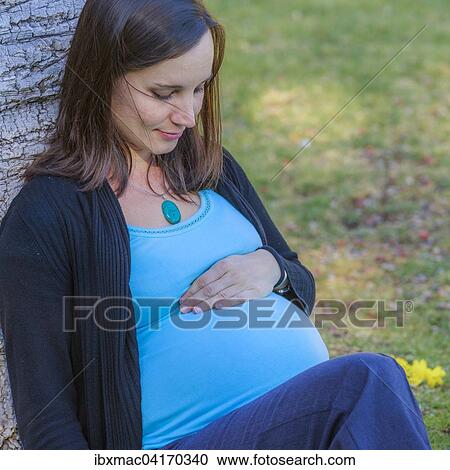 Stock Image - Pregnant woman in a park, Tintenpalast, Windhoek, Namibia, Africa. Fotosearch