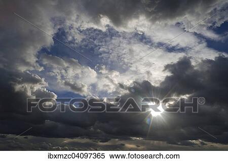 Stock Photography - Rain clouds (Nimbostratus) sun shining through, Germany, Europe. Fotosearch
