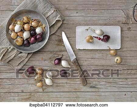 Stock Photo - Red, yellow and white onions with knife. Fotosearch