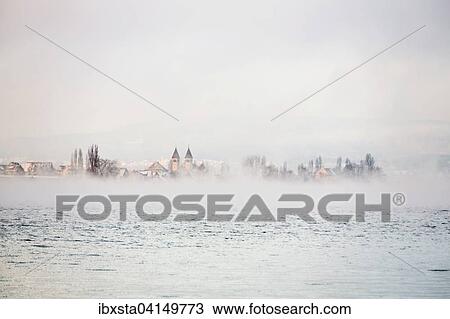Stock Image - Reichenau island dam, Lake Constance, morning atmosphere, fresh snow and fog, Allensbach, Baden-Wurttemberg, Germany, Europe. Fotosearch