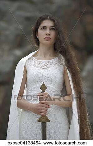 Reminiscence to Joan of Arc, Jeanne d'Arc, young woman in a white dress with a sword View Large Photo Image Picture - Reminiscence to Joan of Arc, Jeanne d'Arc, young woman in a white dress with a sword. Fotosearch