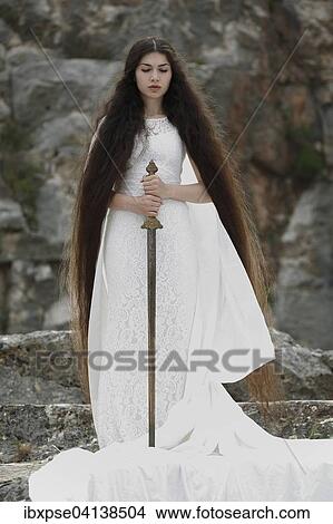 Picture - Reminiscence to Joan of Arc, Jeanne d'Arc, young woman in a white dress with a sword. Fotosearch