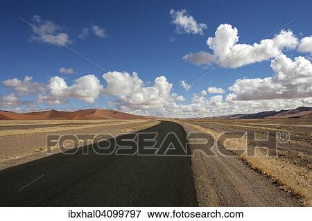 Road to the Sossusvlei, sand dunes of the Namib Desert at the back, Namib-Naukluft National Park, Namibia, Africa View Large Photo Image Stock Photo - Road to the Sossusvlei, sand dunes of the Namib Desert at the back, Namib-Naukluft National Park, Namibia, Africa. Fotosearch