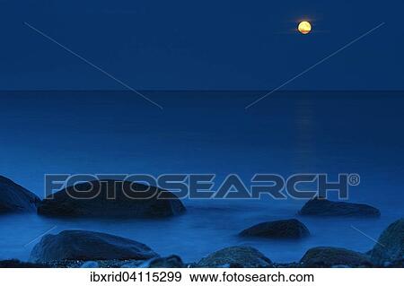 Stock Photo - Rocks in the Baltic Sea at the full moon, Fehmarn, Schleswig-Holstein, Germany, Europe. Fotosearch