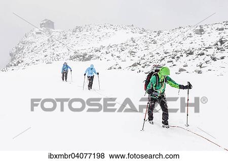 Rope team in a storm during the ascent of Mt Schwarzenstein via the glacier, Schwarzenstein Refuge at the back, Ahrntal Valley, Tauferer Valley,, Puster Valley, South Tyrol, Italy, Europe View Large Photo Image Stock Photo - Rope team in a storm during the ascent of Mt Schwarzenstein via the glacier, Schwarzenstein Refuge at the back, Ahrntal Valley, Tauferer Valley,, Puster Valley, South Tyrol, Italy, Europe. Fotosearch