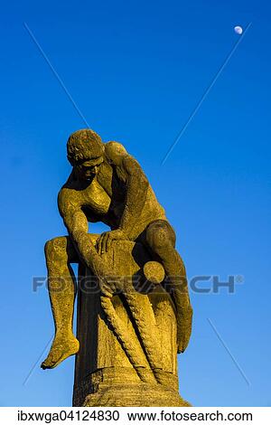Stock Image - Sculpture, the tug-of-war man by Nikolaus Friedrich, Cologne, North Rhine-Westphalia, Germany, Europe. Fotosearch