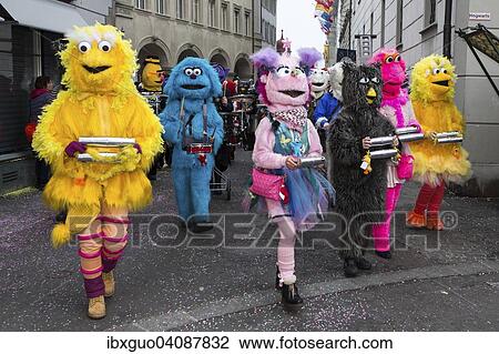 Stock Image - Sesame Street characters, costumes of Guggenmusig Fodlitatscher, traditional carnival celebrations in Lucerne, Switzerland, Europe. Fotosearch