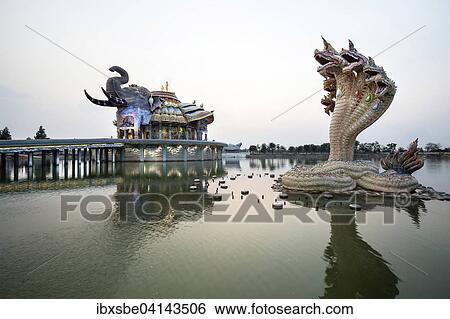Stock Photograph - Seven-headed Naga serpent in front of the Elephant Temple Thep Wittayakhom Vihara, Wittayakom, dusk, Wat Baan Rai, Korat, Nakhon Ratchasima Province, Isaan, Isan, Thailand, Asia. Fotosearch