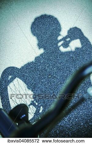 Shadow of man riding a bicycle on street View Large Photo Image Stock Image - Shadow of man riding a bicycle on street. Fotosearch