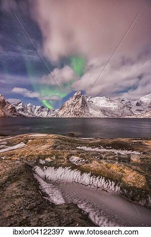 Small aurora with clouds, rocks and ice, mountains at the back, Hamnoy Island, Lofoten, Norway, Europe View Large Photo Image Stock Photo - Small aurora with clouds, rocks and ice, mountains at the back, Hamnoy Island, Lofoten, Norway, Europe. Fotosearch