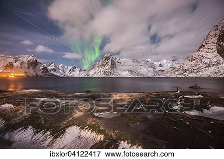 Small aurora with clouds, rocks and ice, small town and mountains at the back, Hamnoy Island, Lofoten, Norway, Europe View Large Photo Image Stock Photo - Small aurora with clouds, rocks and ice, small town and mountains at the back, Hamnoy Island, Lofoten, Norway, Europe. Fotosearch