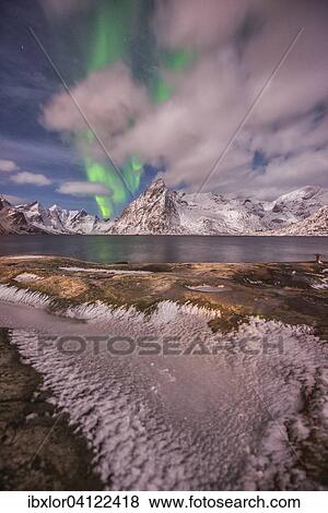 Small aurora with clouds, rocks and ice, mountains at the back, Hamnoy Island, Lofoten, Norway, Europe View Large Photo Image Stock Photo - Small aurora with clouds, rocks and ice, mountains at the back, Hamnoy Island, Lofoten, Norway, Europe. Fotosearch