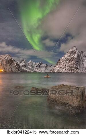 Small aurora with clouds, rocks by the ocean, small town and mountains at the back, Hamnoy Island, Lofoten, Norway, Europe View Large Photo Image Stock Photography - Small aurora with clouds, rocks by the ocean, small town and mountains at the back, Hamnoy Island, Lofoten, Norway, Europe. Fotosearch