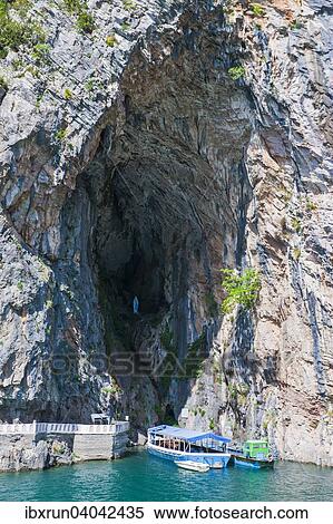 Small tourist boat in a cave on Koman reservoir, Balkan, Albania, Europe View Large Photo Image Stock Photography - Small tourist boat in a cave on Koman reservoir, Balkan, Albania, Europe. Fotosearch