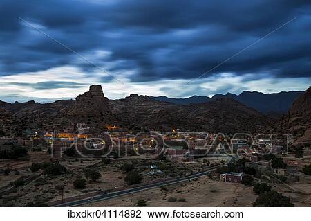 Small village of Aguard Oudad with brightly painted houses in front of the rock Chapeau Napoleon, dramatic clouds, evening, Tafraoute, Anti Atlas, Southern Morocco, Morocco, Africa View Large Photo Image Stock Image - Small village of Aguard Oudad with brightly painted houses in front of the rock Chapeau Napoleon, dramatic clouds, evening, Tafraoute, Anti Atlas, Southern Morocco, Morocco, Africa. Fotosearch