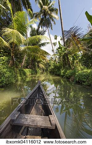 Small wooden boat pushes through a palm-lined canal, backwaters, Champakulam, Kerala, Malabar Coast, South India, India, Asia View Large Photo Image Stock Image - Small wooden boat pushes through a palm-lined canal, backwaters, Champakulam, Kerala, Malabar Coast, South India, India, Asia. Fotosearch