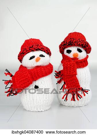 Stock Image - Snowmen, hand-knitted. Fotosearch