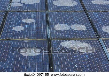 Stock Photography - Solar panels with spots. Fotosearch