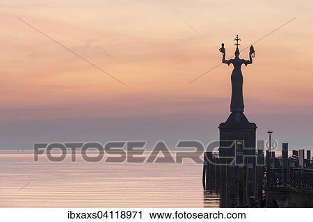 Stock Image - Statue of Imperia at the entrance of the harbour of Konstanz at dawn, historic centre, Konstanz, Baden-Wurttemberg, Germany, Europe. Fotosearch