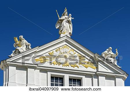 Stock Photo - Stucco work, the eye of god in the gable tympanum, at the top the sculpture group of St Stephen, St Mary and St Severin, baroque-style St. Stephen's Cathedral, historic centre, Passau, Lower Bavaria, Bavaria, Germany, Europe. Fotosearch