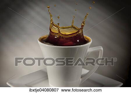 Sugar cube falling into a cup of coffee, splashing coffee View Large Photo Image Stock Photo - Sugar cube falling into a cup of coffee, splashing coffee. Fotosearch