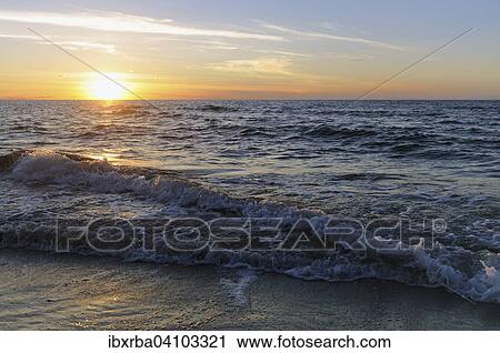 Stock Image - Sunset by the Baltic Sea, West beach, Darss, Western Pomerania Lagoon Area National Park, Mecklenburg-Western Pomerania, Germany, Europe. Fotosearch