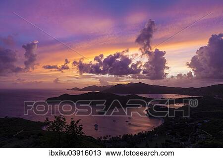 Stock Image - Sunset from Shirley Heights, views over English Harbour, Antigua, Antigua and Barbuda, North America. Fotosearch