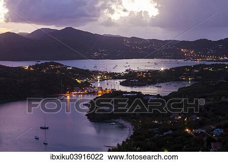 Stock Image - Sunset from Shirley Heights, views over English Harbour, Antigua, Antigua and Barbuda, North America. Fotosearch