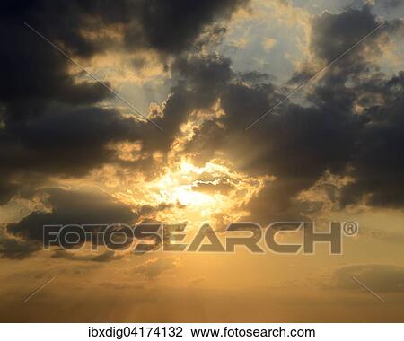 Sunset in a dramatic cloud filled sky View Large Photo Image Stock Image - Sunset in a dramatic cloud filled sky. Fotosearch