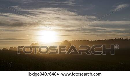 Picture - Sunset with dust from harvesting, Swabian Jura, Baden-Wurttemberg, Germany, Europe. Fotosearch