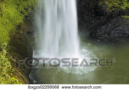 Stock Photo - Surge of water falling into a lake, Bridal Veil Falls, Raglan, Waikato, North Island, New Zealand, Oceania. Fotosearch