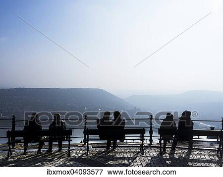 Tourists sitting on benches, viewing the vineyards, Rudesheim am Rhein, Rhine Gorge, Hesse, Germany, Europe View Large Photo Image Stock Photo - Tourists sitting on benches, viewing the vineyards, Rudesheim am Rhein, Rhine Gorge, Hesse, Germany, Europe. Fotosearch