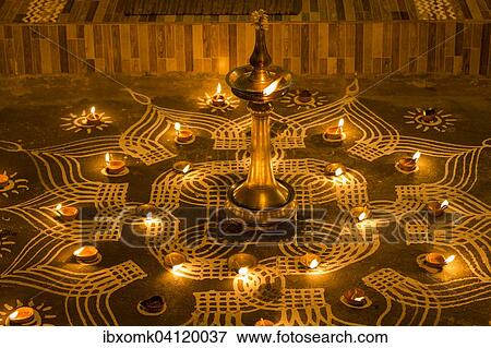 Stock Photo - Traditional Rangoli, Kolam or Muggu, decorative pattern and oil lamps in front of house entrance, Tamil quarter, Kochi, Kerala, India, Asia. Fotosearch