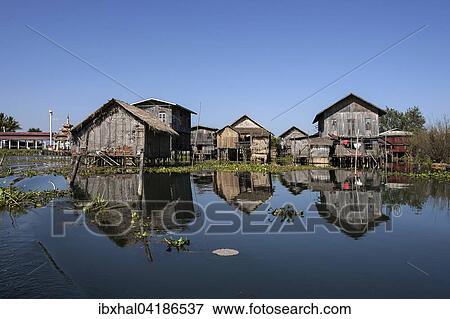 Stock Photo - Traditional stilt houses in Inle Lake, reflection in the water, Shan State, Myanmar, Asia. Fotosearch