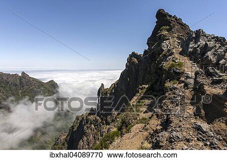 Trail from the Pousada do Arieiro to Pico Ruivo, Passat clouds pile up on the mountain slopes, Parque Natural da Madeira, Madeira, Portugal, Europe View Large Photo Image Stock Image - Trail from the Pousada do Arieiro to Pico Ruivo, Passat clouds pile up on the mountain slopes, Parque Natural da Madeira, Madeira, Portugal, Europe. Fotosearch