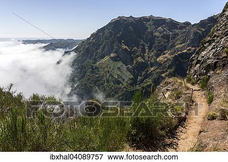 Trail from the Pousada do Arieiro to Pico Ruivo, Passat clouds pile up on the mountain slopes, Parque Natural da Madeira, Madeira, Portugal, Europe View Large Photo Image Stock Photo - Trail from the Pousada do Arieiro to Pico Ruivo, Passat clouds pile up on the mountain slopes, Parque Natural da Madeira, Madeira, Portugal, Europe. Fotosearch