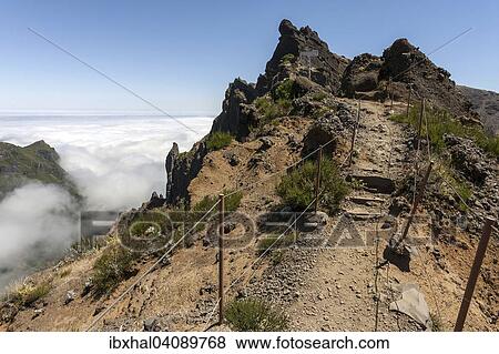 Trail from the Pousada do Arieiro to Pico Ruivo, Passat clouds pile up on the mountain slopes, Parque Natural da Madeira, Madeira, Portugal, Europe View Large Photo Image Stock Photo - Trail from the Pousada do Arieiro to Pico Ruivo, Passat clouds pile up on the mountain slopes, Parque Natural da Madeira, Madeira, Portugal, Europe. Fotosearch