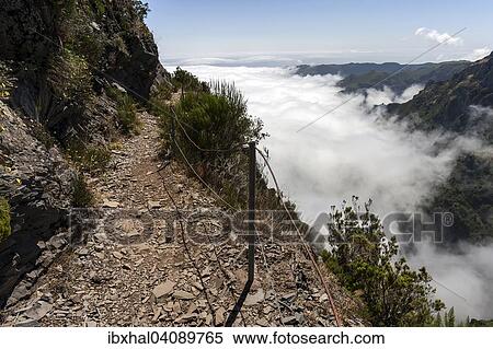 Trail from the Pousada do Arieiro to Pico Ruivo, Passat clouds pile up on the mountain slopes, Parque Natural da Madeira, Madeira, Portugal, Europe View Large Photo Image Stock Photography - Trail from the Pousada do Arieiro to Pico Ruivo, Passat clouds pile up on the mountain slopes, Parque Natural da Madeira, Madeira, Portugal, Europe. Fotosearch