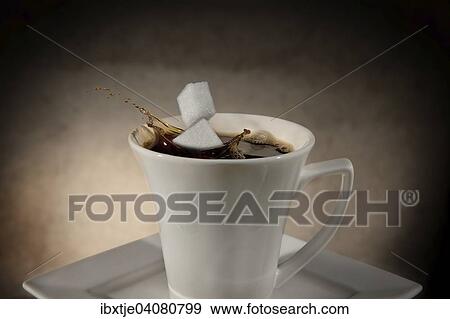 Two sugar cubes falling into a cup of coffee, splashing coffee View Large Photo Image Stock Photo - Two sugar cubes falling into a cup of coffee, splashing coffee. Fotosearch