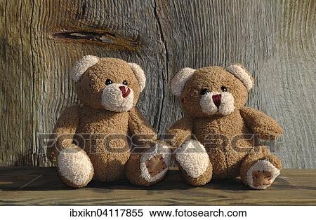 Two teddy bears on a wooden bench and wood behind View Large Photo Image Stock Photography - Two teddy bears on a wooden bench and wood behind. Fotosearch