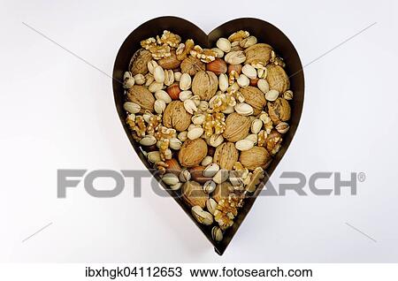 Various nuts, walnuts, hazelnuts, pistachios, in a heart shaped bowl View Large Photo Image Stock Image - Various nuts, walnuts, hazelnuts, pistachios, in a heart shaped bowl. Fotosearch