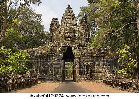 Picture - Victory Gate in the east of Angkor Thom, Avalokiteshvara face tower, Asura and Deva statues, demons balustrade on the bridge, Angkor Thom, Siem Reap, Cambodia, Asia. Fotosearch
