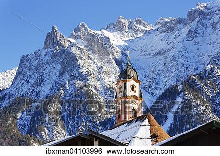 Stock Photograph - Viererspitze and Western Karwendelspitze mountain, St. Peter and St. Paul's parish church, Mittenwald, Karwendel, Werdenfelser Land, Upper Bavaria, Bavaria, Germany, Europe. Fotosearch
