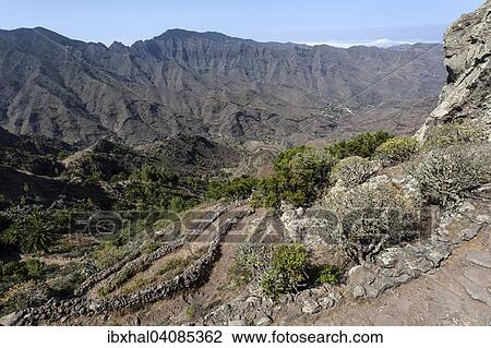 View from the hiking trail between the Mirador Degollada de Paraza and La Laja, La Gomera, Canary Islands, Spain, Europe View Large Photo Image Stock Image - View from the hiking trail between the Mirador Degollada de Paraza and La Laja, La Gomera, Canary Islands, Spain, Europe. Fotosearch