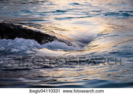 Wave around a stone, Praslin, Seychelles, Africa View Large Photo Image Stock Image - Wave around a stone, Praslin, Seychelles, Africa. Fotosearch